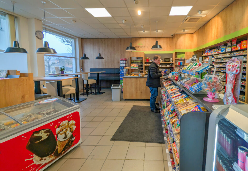 Eine Person steht an der Kasse unseres Tankshops